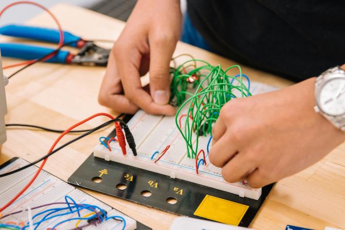 Close up of hands working on an audio mixer