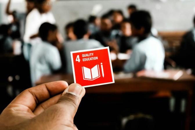 hand holding an SDG 4: quality education card 