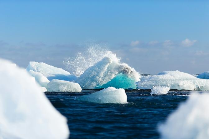 icebergs floating on water