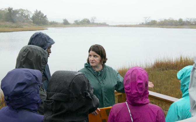 a crowd of people in front of a lake