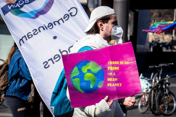 man holding a banner in a demonstration