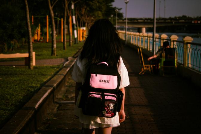 Girl with a backpack walking forward