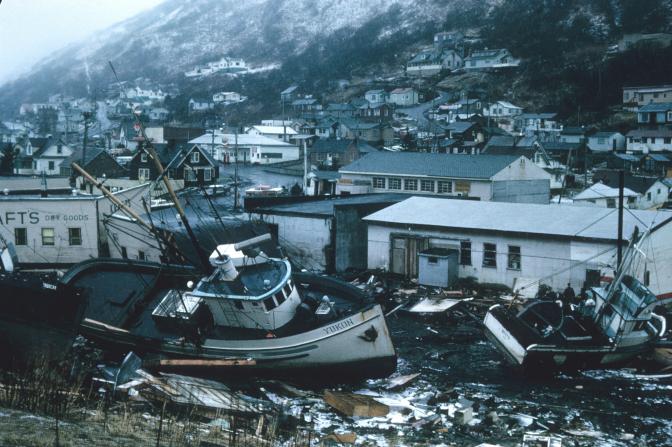 Town affected by an earthquake and a tsunami with a boat crashed into an area with houses